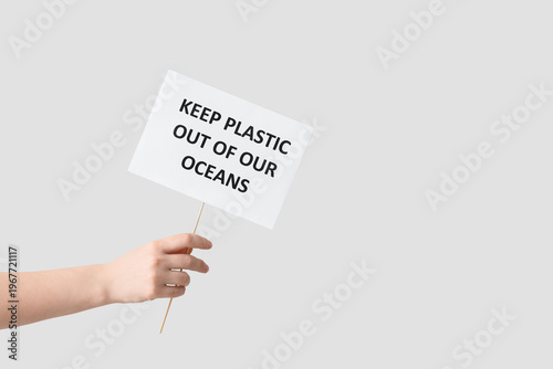 Hands holding paper sheet w...