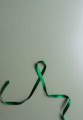 Green ribbon symbolizing mental health awareness and support