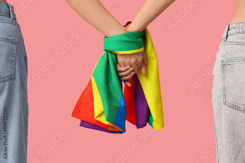 Women with LGBT flag holdin...