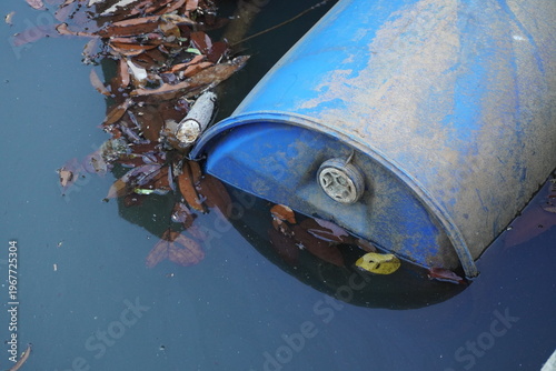 A blue barrel floating in water with half of its body above the surface.