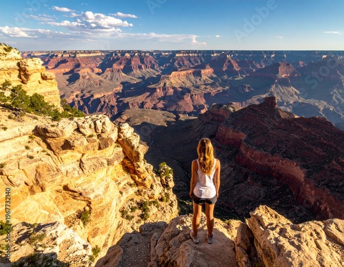 Wallpaper Mural Woman admiring the vast and breathtaking Grand Canyon landscape at sunset, showcasing the beauty of nature and adventure. Torontodigital.ca