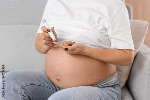 Young pregnant woman using ...