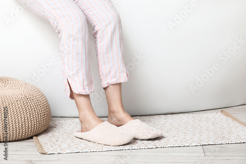 Female legs in soft slipper...