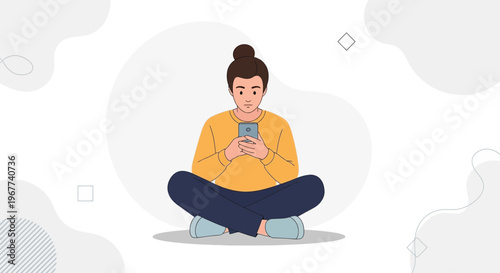 Young woman sitting cross-legged, looking at her smartphone, minimalist background