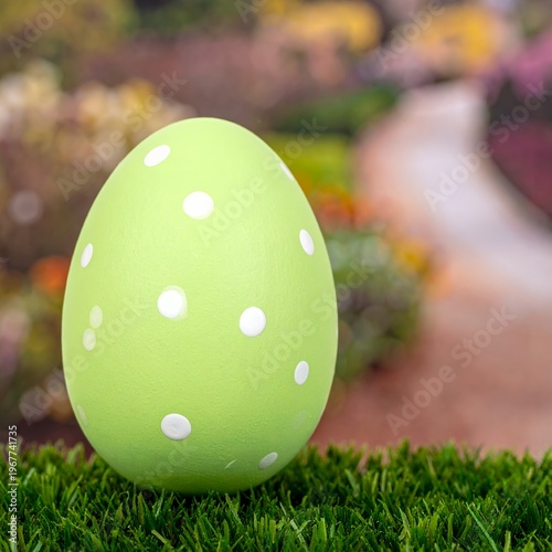 Vibrant Green Easter Egg with White Polka Dots on Grass.