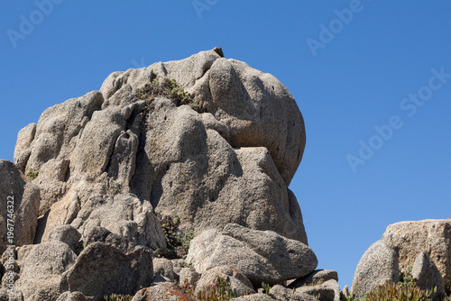 Granite rock formation under blue sky on the coast of Punta de Tralca, Chile