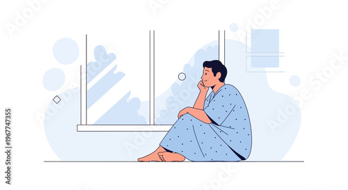 Man in Hospital Gown Sitting by Window, Looking Out with Thoughtful Expression