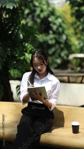 Ambitious businesswoman working on laptop in modern office, collaborating with diverse team, brainstorming ideas, planning strategy, and driving innovation and career success.
