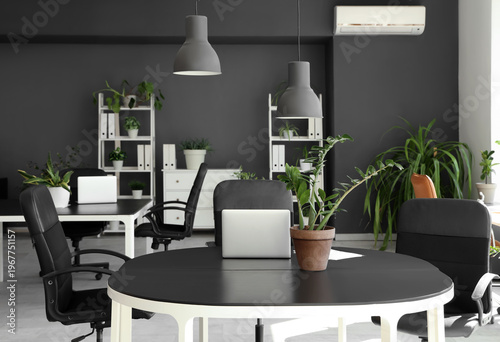 Laptop with plant on desk i...