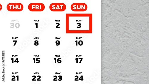 Close-up of the date May 3rd marked with a red cursor on the wall calendar 2026