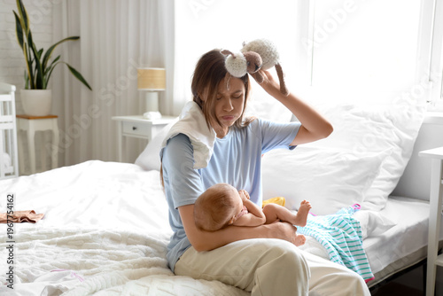 Stressed young mother suffe...