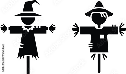 Two traditional scarecrows protecting crops in a field with bird control with old fashioned with human shape