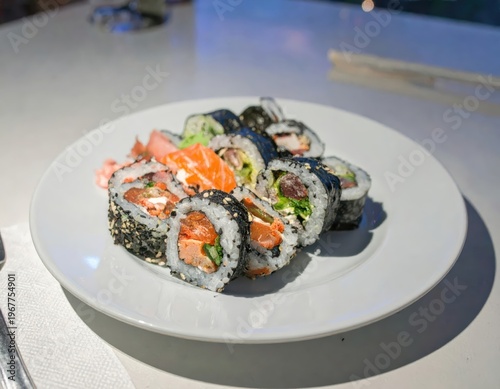 Fresh Sushi Rolls and Salmon on White Plate