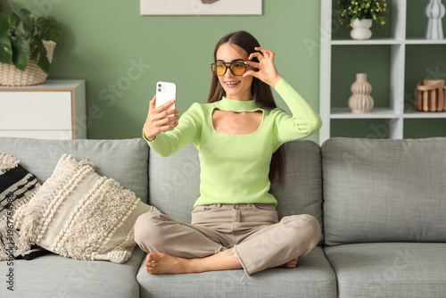 Young woman in sunglasses w...