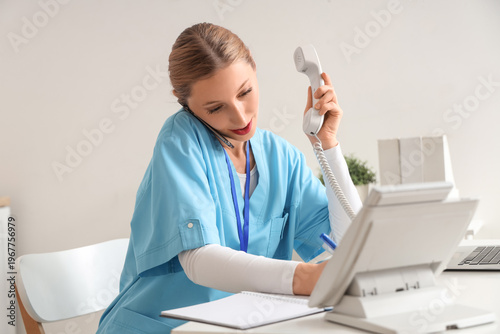 Happy female doctor writing...