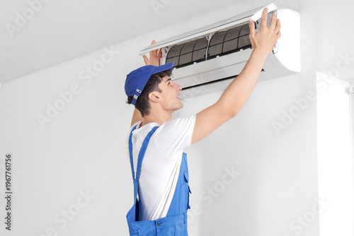 Male worker repairing air c...