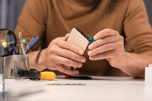 Male technician repairing m...