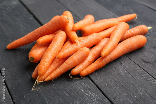 Many fresh carrots on black...