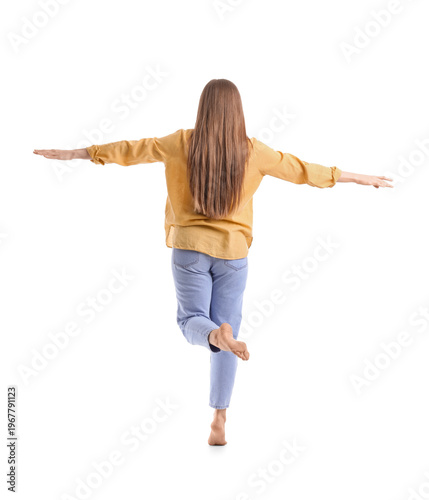 Young woman balancing on wh...