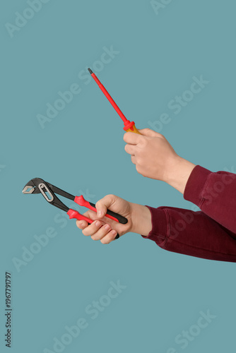 Worker with pliers and scre...