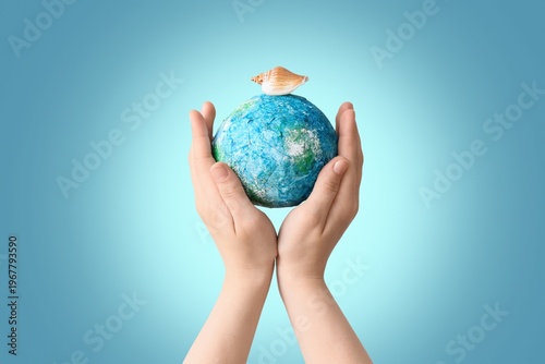 Hands holding model of Eart...