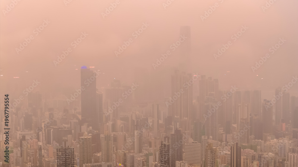 Fototapeta premium March 27 2026 HONG KONG, CHINA Warm hazy skyline rising over Kowloon