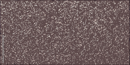 Close up texture of a dark brown grainy and slightly speckled surface
