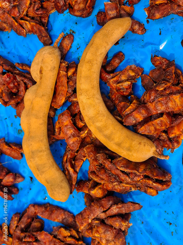 Tamarind, a tropical fruit with a sweet and sour taste, is used as an ingredient in cooking.