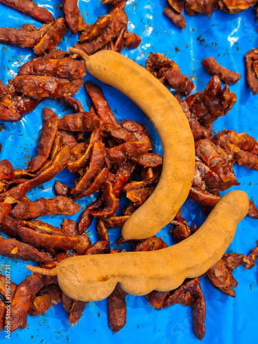 Tamarind, a tropical fruit with a sweet and sour taste, is used as an ingredient in cooking.