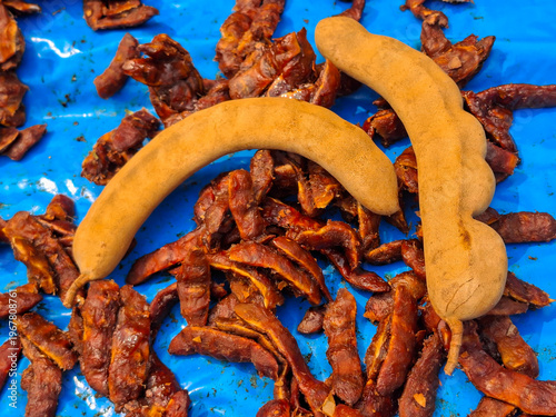 Tamarind, a tropical fruit with a sweet and sour taste, is used as an ingredient in cooking.