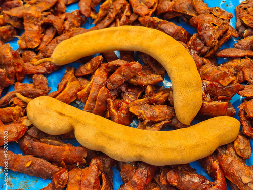 Tamarind, a tropical fruit with a sweet and sour taste, is used as an ingredient in cooking.