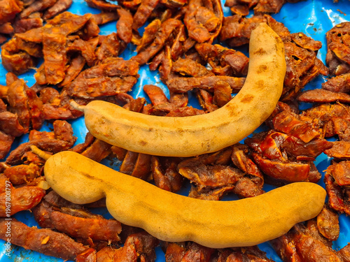 Tamarind, a tropical fruit with a sweet and sour taste, is used as an ingredient in cooking.