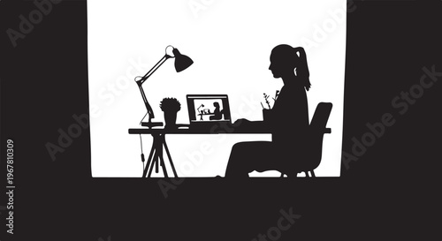 Woman sitting at desk with laptop and lamp chair