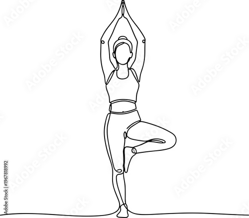 Woman in yoga tree pose standing.