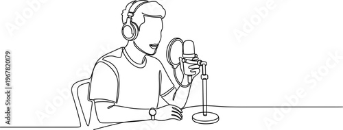 Man wearing headphones speaking into microphone.