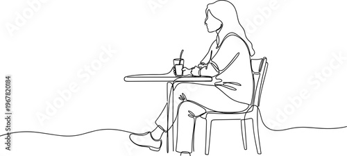 Woman sitting alone at small table.