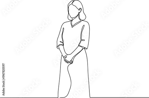 Woman standing in a long dress.