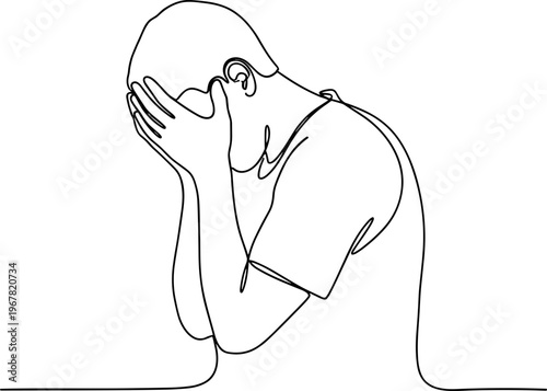 Sad man covering his face.