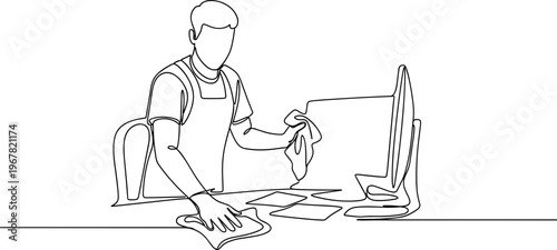 Man wearing apron working on computer.