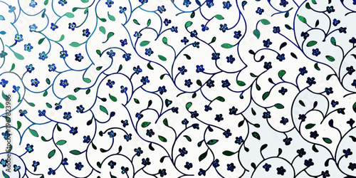 Intricate floral pattern with blue blossoms and green foliage on white