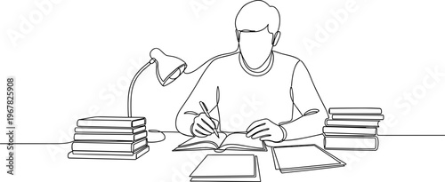 Man sitting at desk writing book.