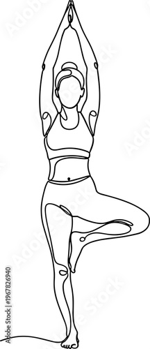 Woman in yoga tree pose standing.
