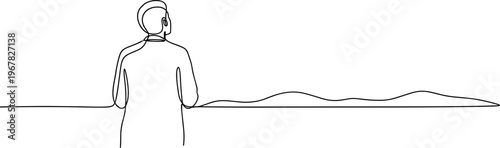 Man looking out at distant landscape.