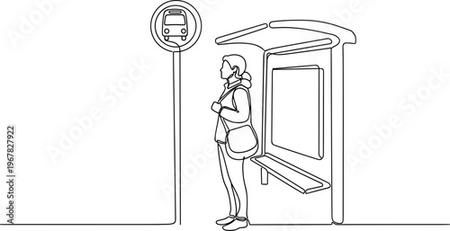 Woman standing at bus stop alone.