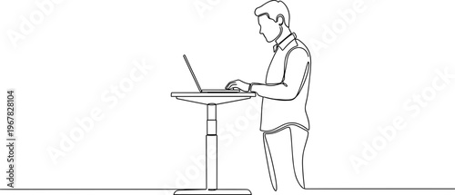 Man working on laptop computer standing.