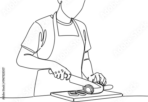 Person wearing apron cutting on board.