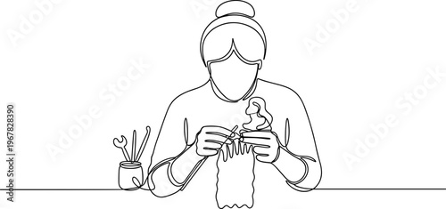 Woman wearing face mask sewing fabric.