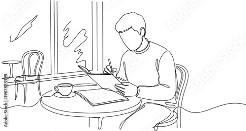 Man sitting at a table writing.