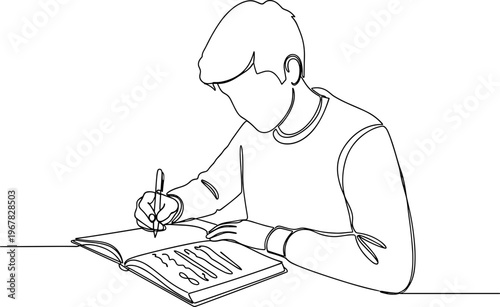 Young man writing in notebook.