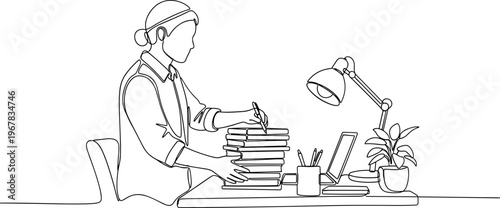 Woman sitting at desk with books.